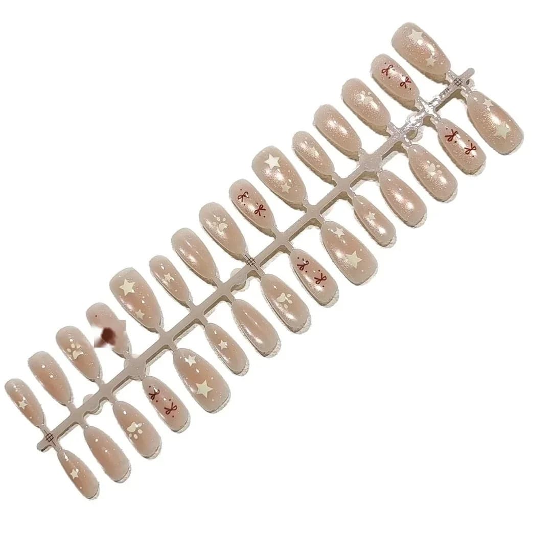 Faux ongles nude rose effet œil de chat avec nœud et perles étoiles